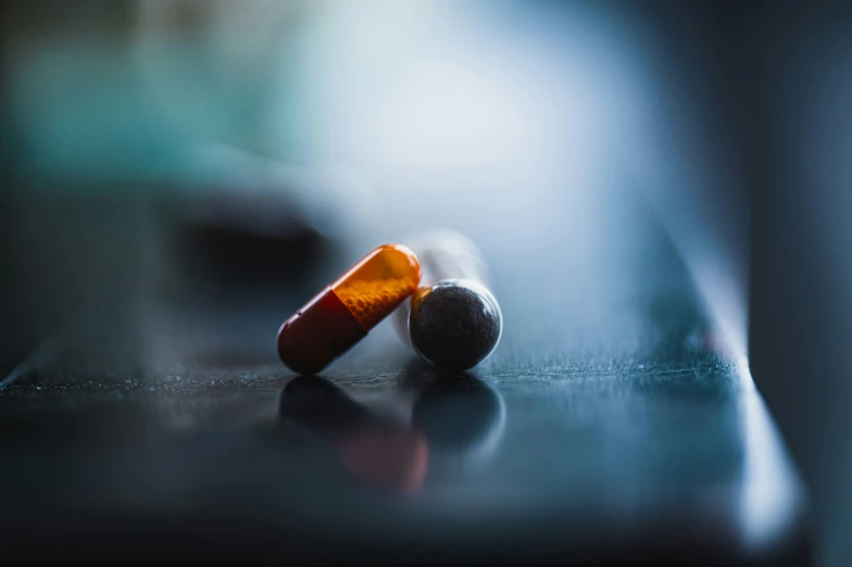 an orange pill sitting on top of a counter