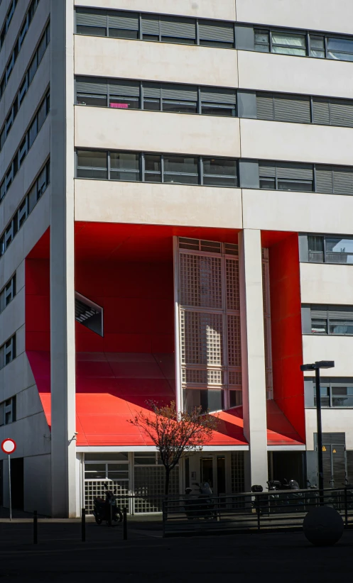 an outside view of a building with a red and white architecture