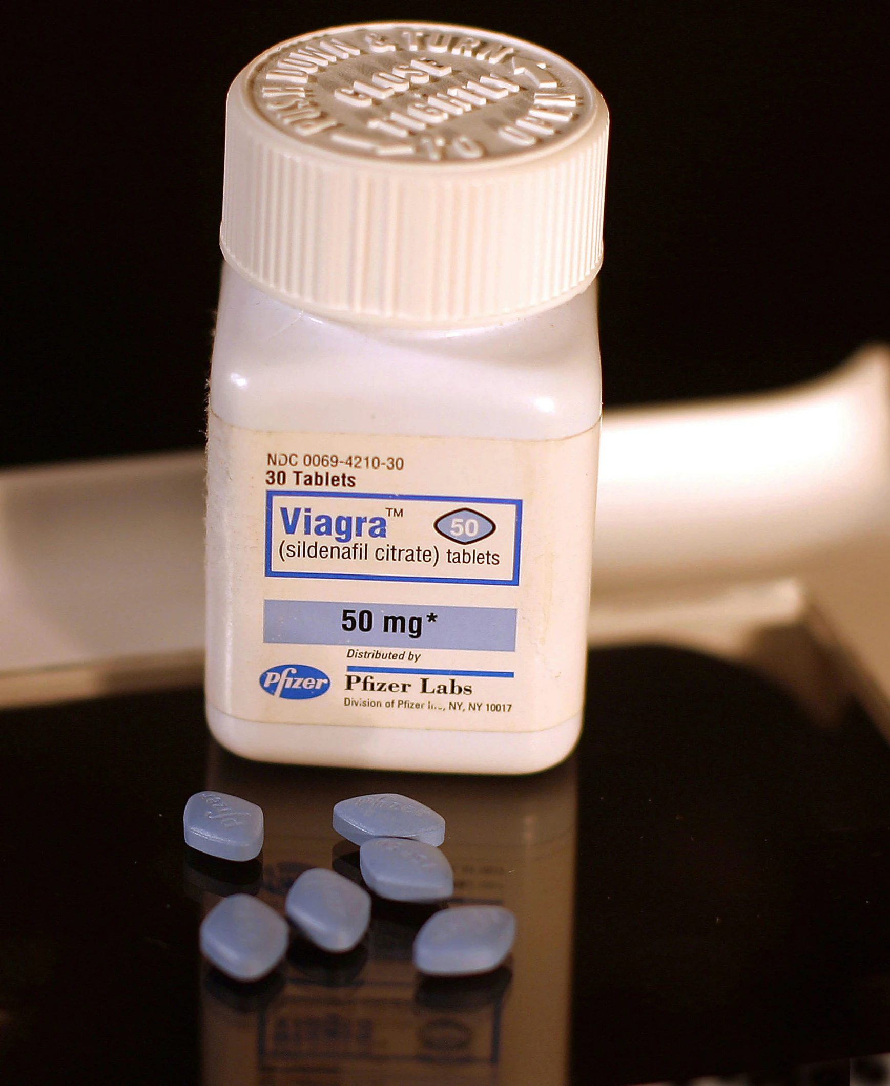 two capsule pills on a table beside an ivapre