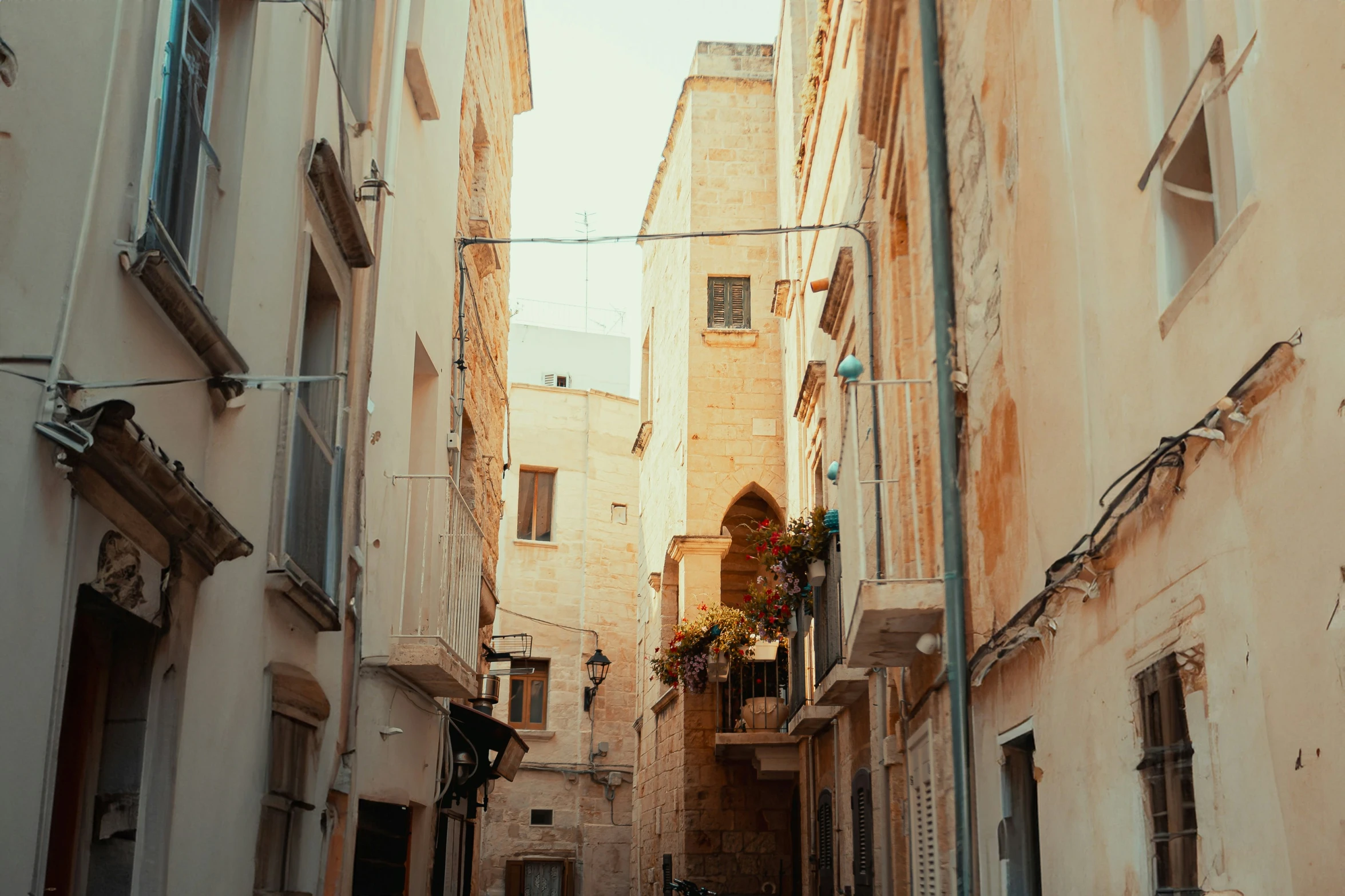 several narrow alleyways are in a city on a sunny day