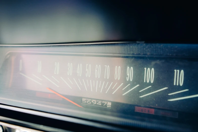 a black car dashboard and meter and its lights showing