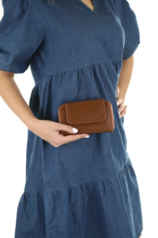 a person holding a small brown leather bag