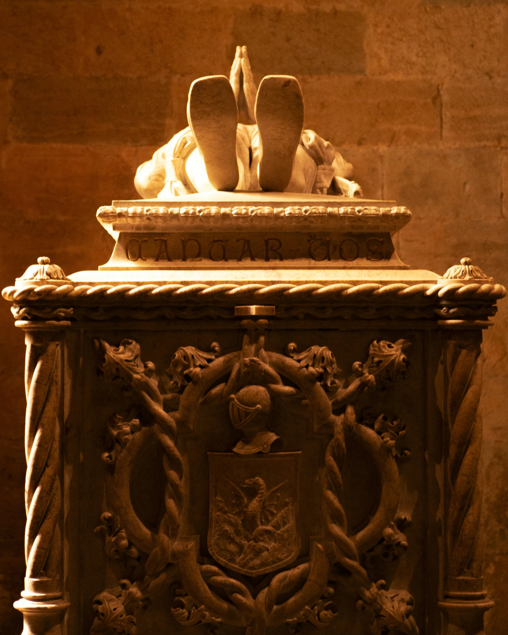 a statue with two birds above it next to some wall