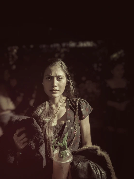 a woman standing with a vase full of flowers