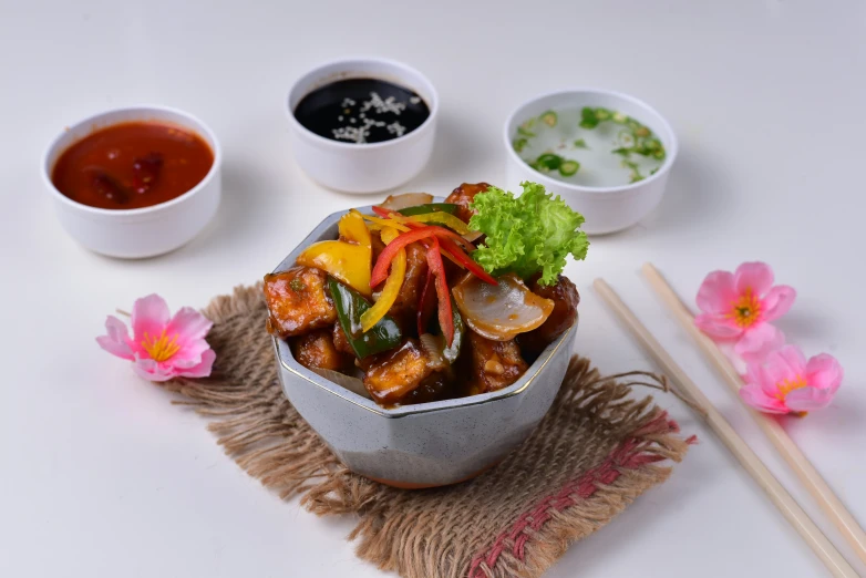 some kind of food on a table with chop sticks