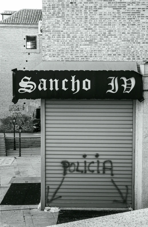 a garage door has graffiti on it near a building