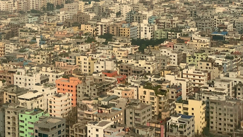 the city is crowded with colorful buildings and green trees