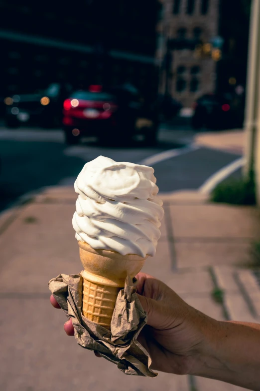 an ice cream cone with a scoop in the hand