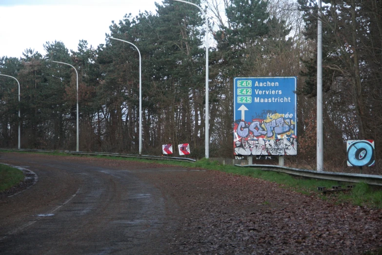 a picture of a sign next to a road