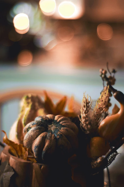 a small, small pumpkin sits on top of a pile of leaves