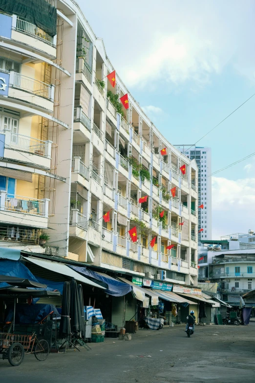 street market in the city with balconies with flowers