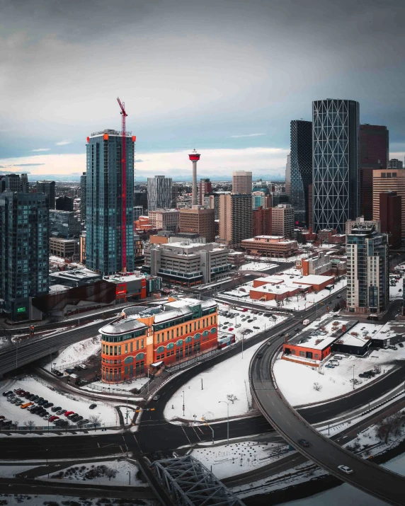 a city filled with tall buildings surrounded by snow