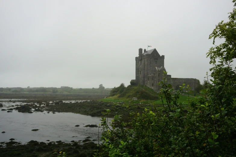 a large castle sits in the middle of a river