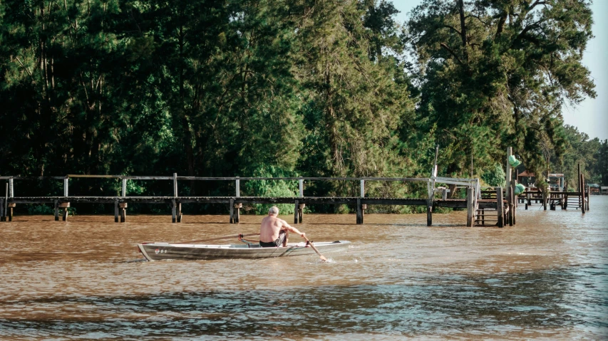 a man that is sitting on a boat in the water