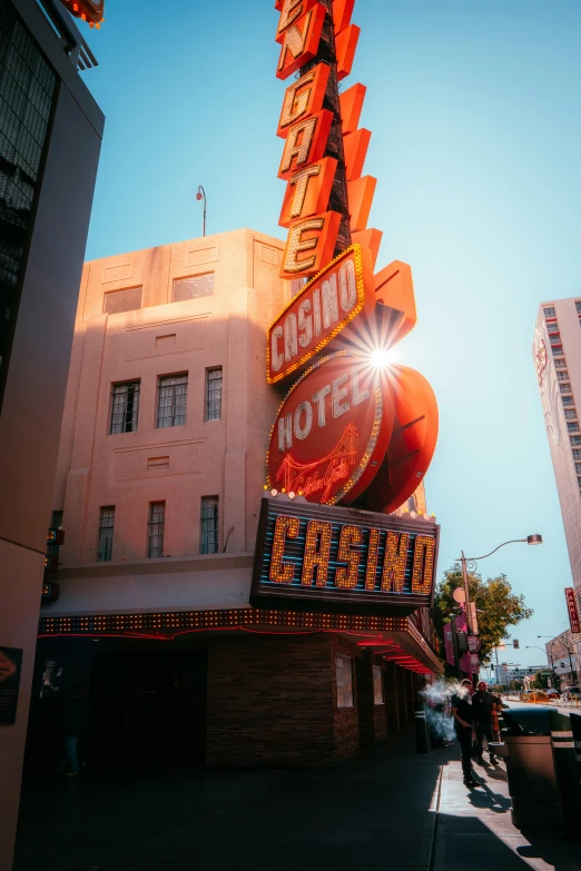 people walk past a building with many business signs on it