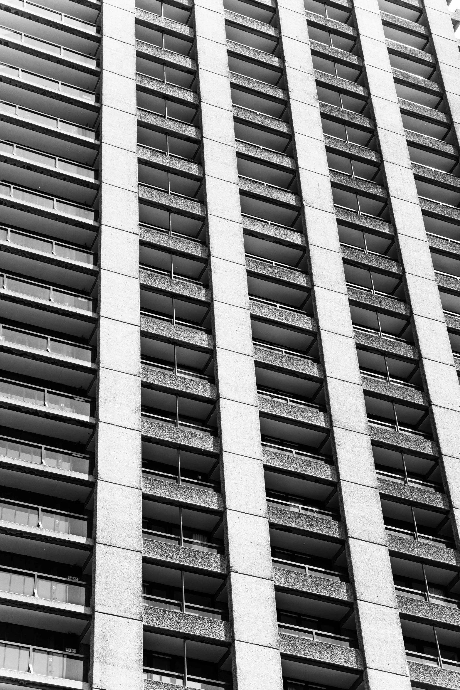 a black and white image of the side of a tall building