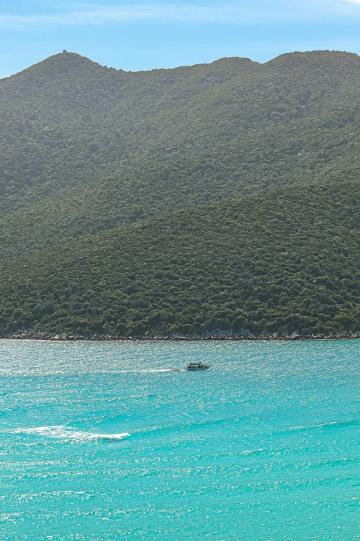 a small boat sailing in the middle of the ocean