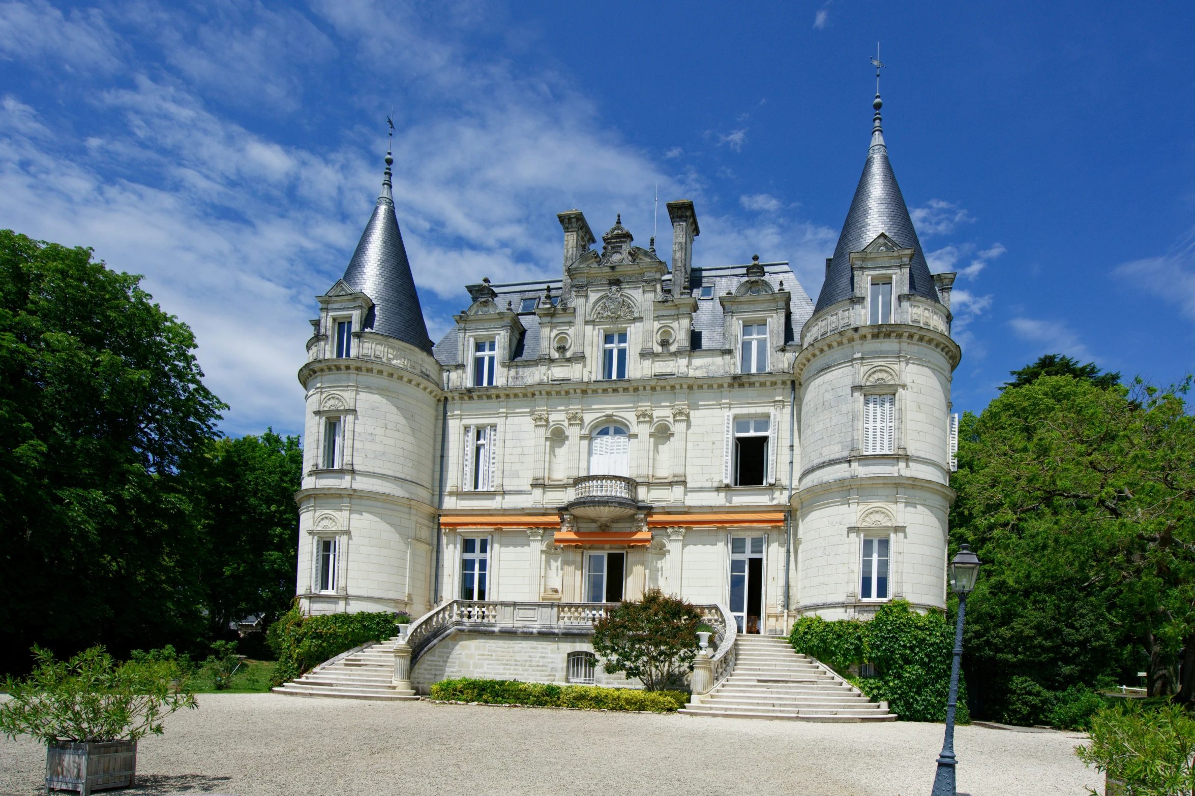 a huge building with towers sitting on the top of a hill