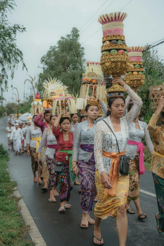 an oriental woman leads a procession down the street