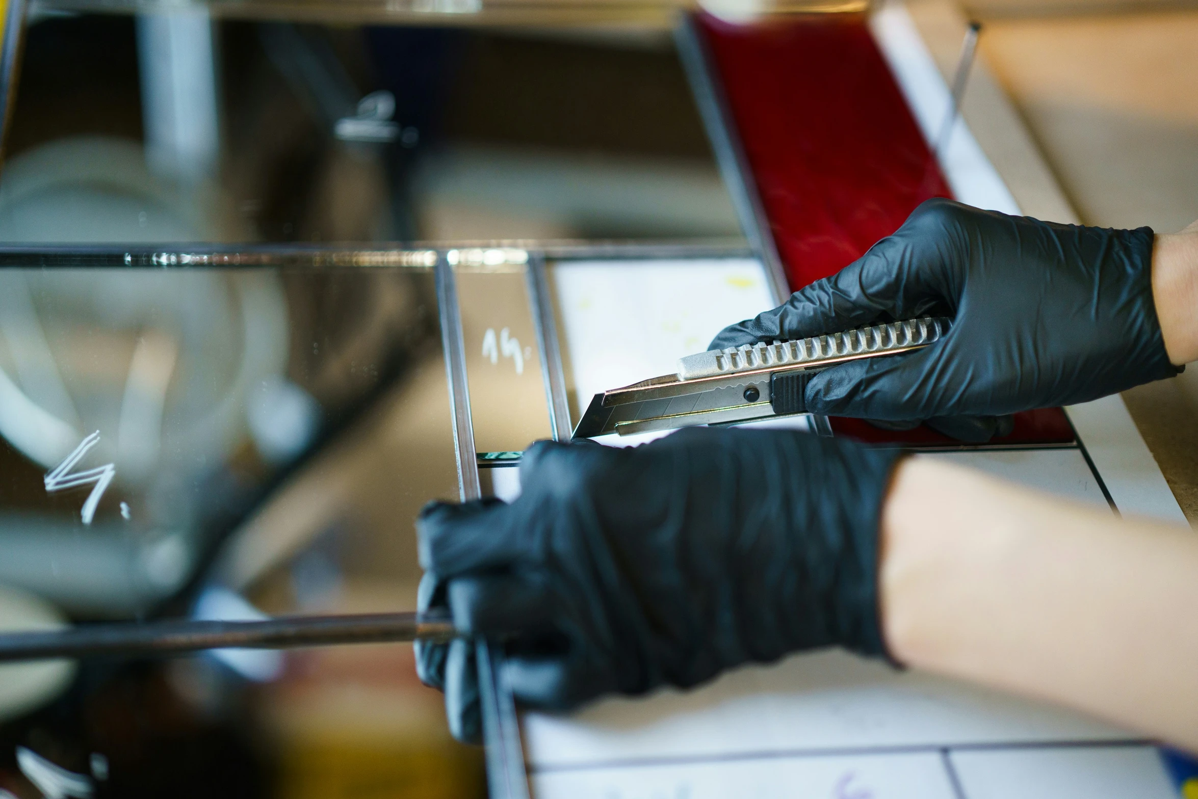 woman in black gloves  metal with a pair of scissors