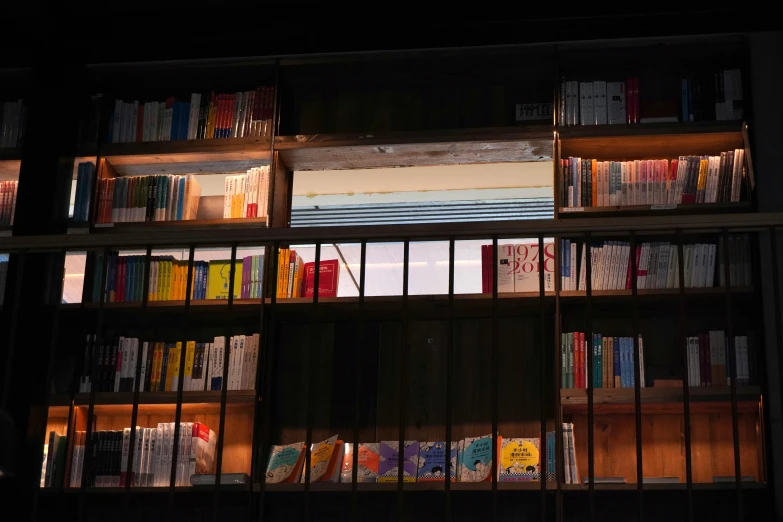 bookshelves full of books and illuminated lights in the dark