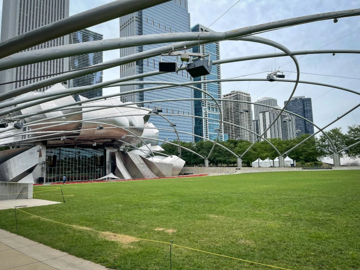 a grassy field with buildings in the background