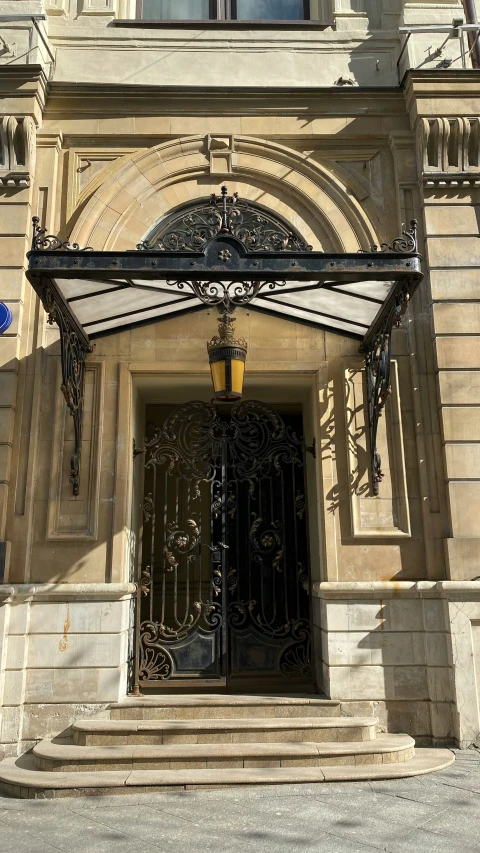 an old church entrance with iron gates and decorative windows