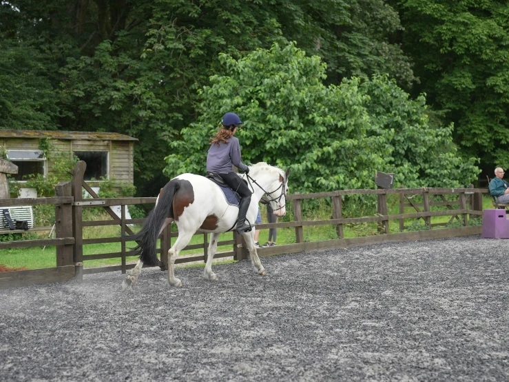 a woman is riding on top of a horse