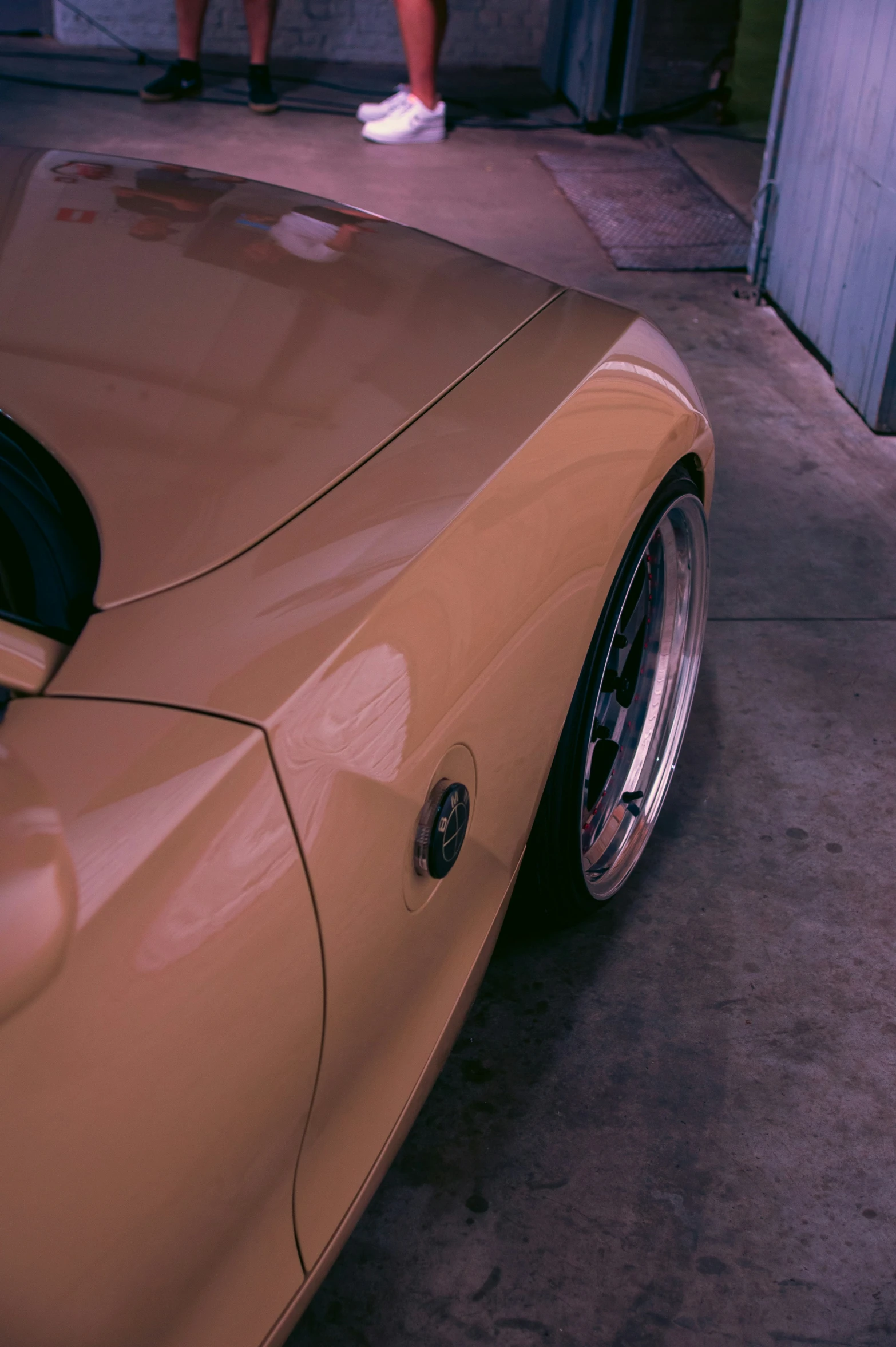 a gold sports car with wheels parked in a garage