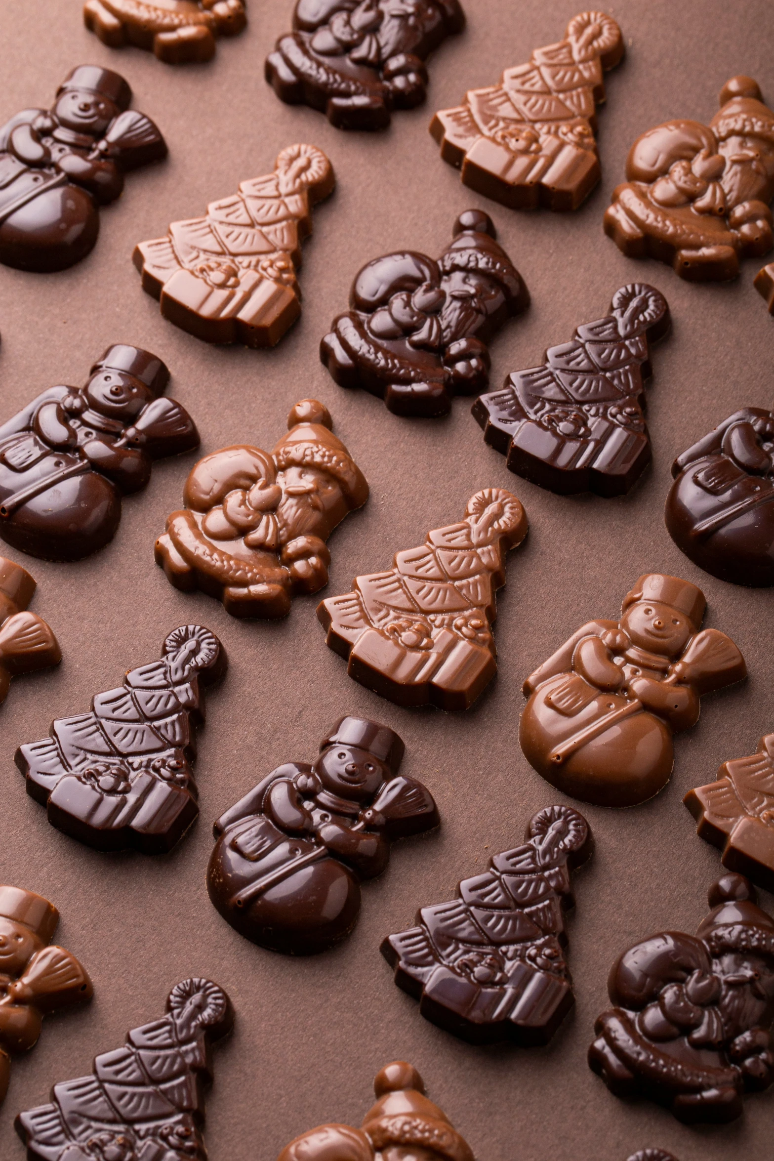 a tray of chocolate treats has christmas decorations on it