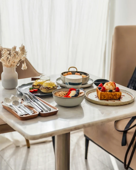 a table topped with plates and bowls of food