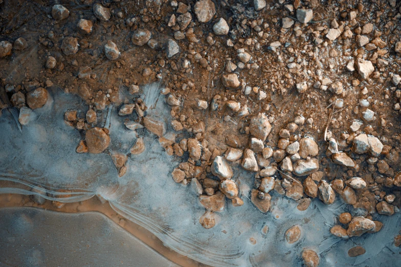 aerial view of rocky area with river bed below