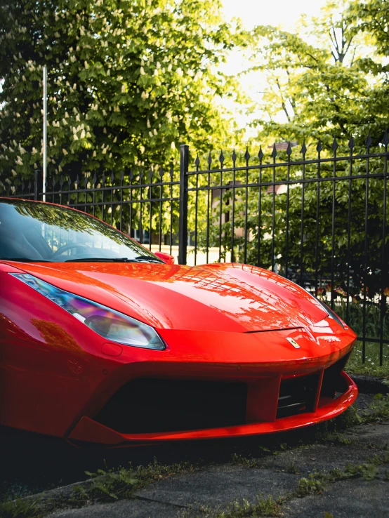 a red sports car parked on the curb