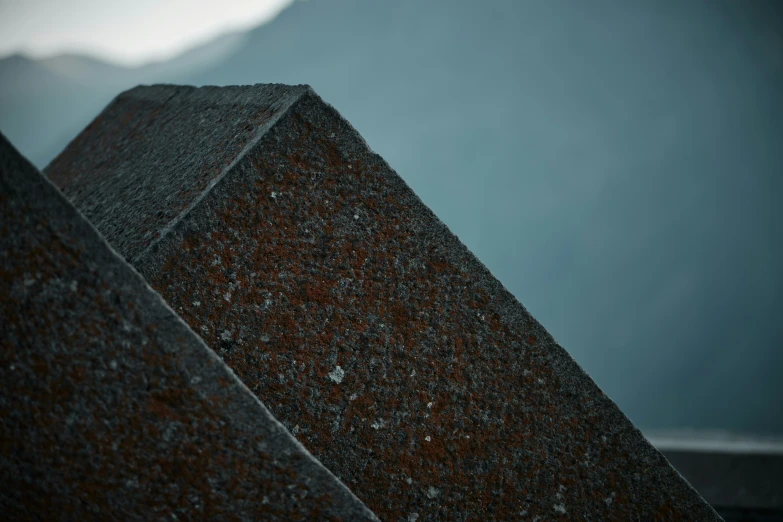 a bird perched on the corner of a stone sculpture