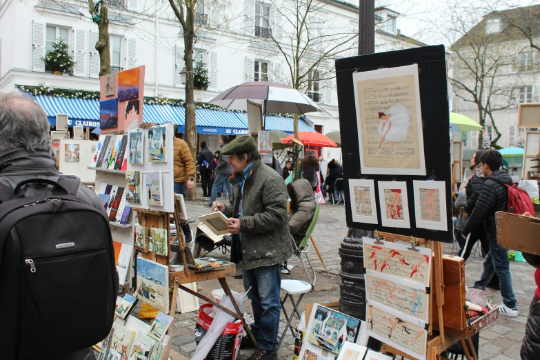 an art market with various paintings and posters for sale