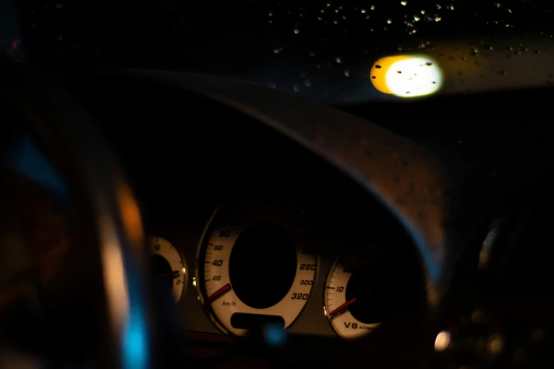 a dashboard of a car at night with bright light