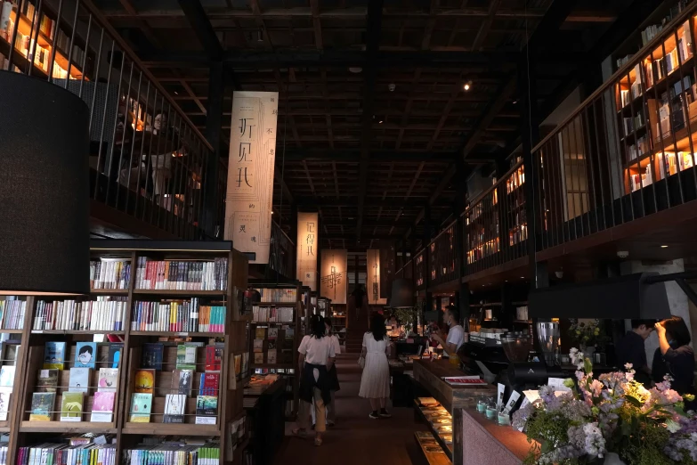 people in a liry with lots of books on shelves