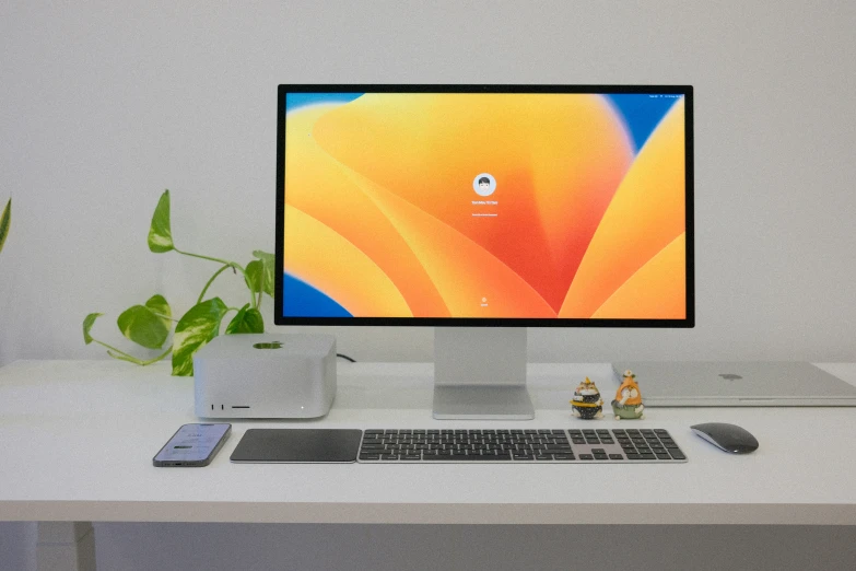 a desk top computer sitting on top of a white table