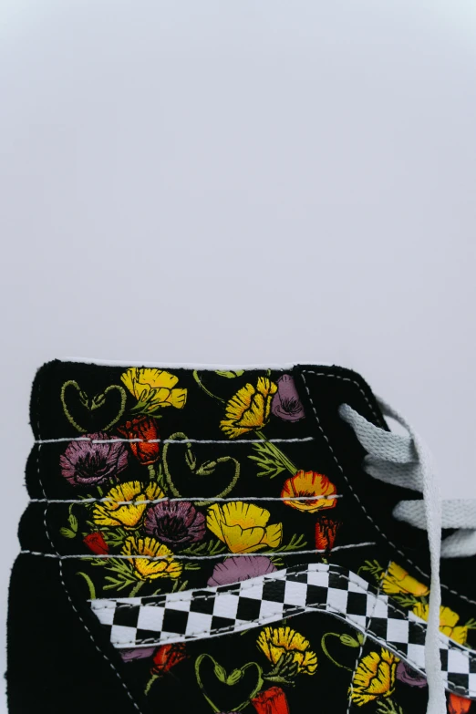 a pair of yellow and black flowers sitting on top of some black and white papers