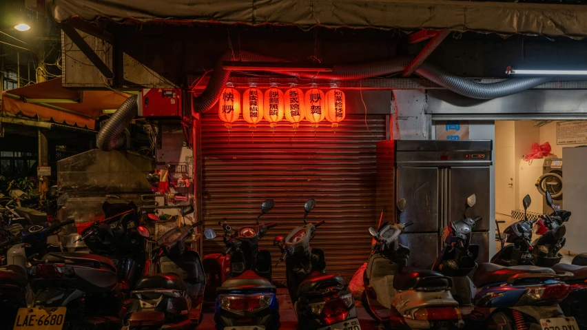 a large number of motorcycles parked outside a shop