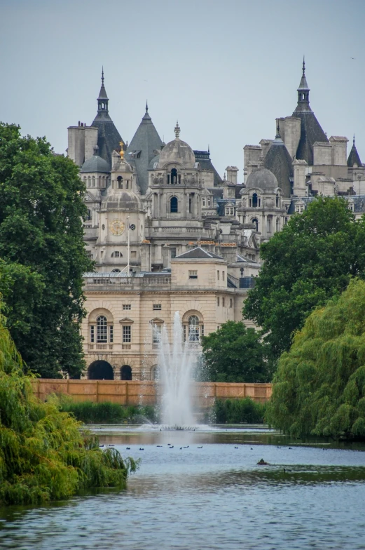 a building on a hill is next to a lake