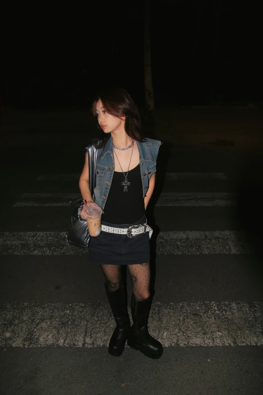 a person in a black dress and boots