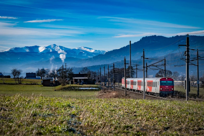 a train traveling along train tracks near mountains