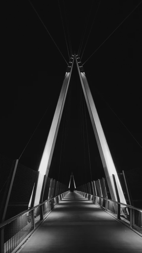 a very dark walkway over some buildings