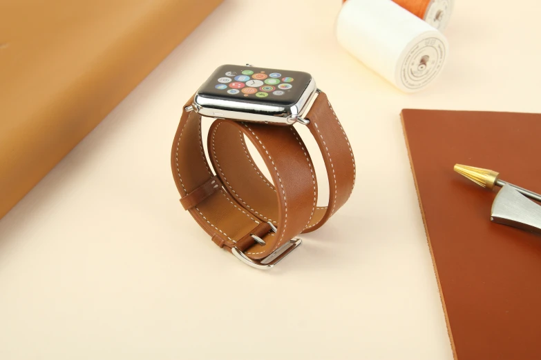 an apple watch is set on a brown strap