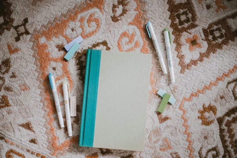 a piece of paper and four straws on top of carpet