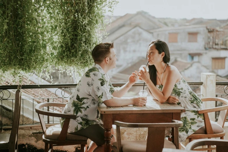 two people sitting at a table having dinner