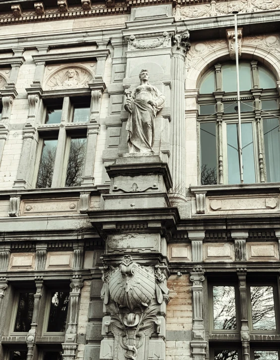 an old building features stone carvings and an elaborate balcony