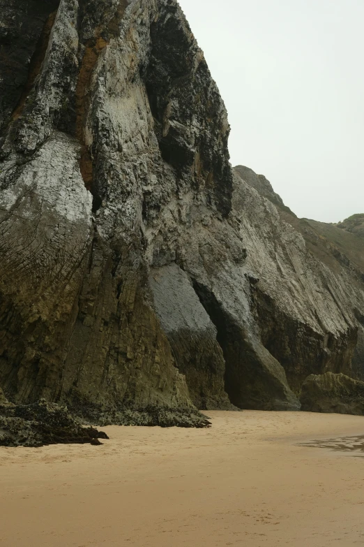 an ocean beach with two large rocks on it