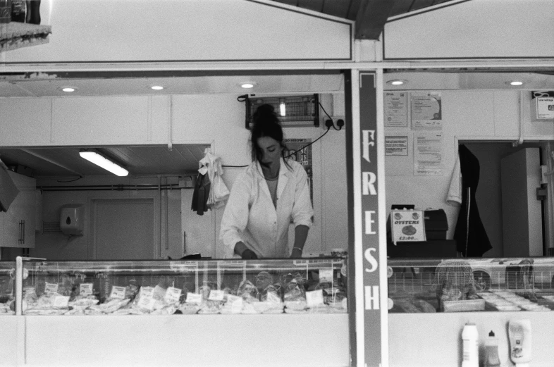 a woman walking past a store front window